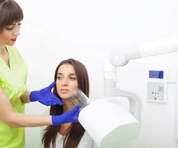 Dental assistant organizing dental instruments before a procedure.
